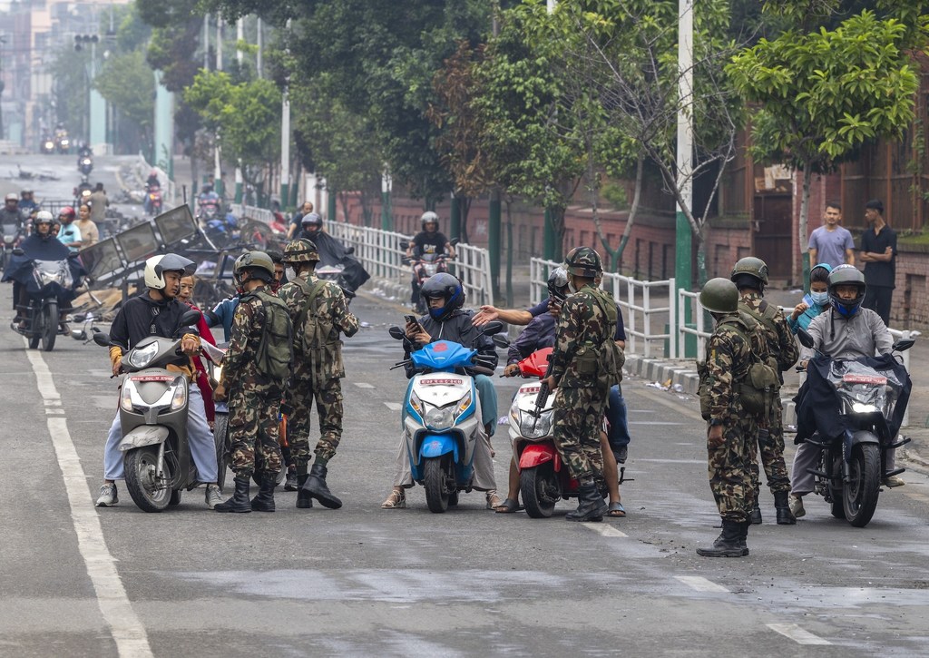 Army personnel check IDs at a checkpoint in Kathmandu after troops were deployed to restore order following youth-led anti-corruption protests that forced the Prime Minister’s resignation.